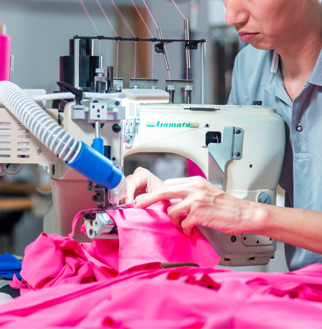 Skilled garment worker performing precision sewing for high-quality custom activewear production.