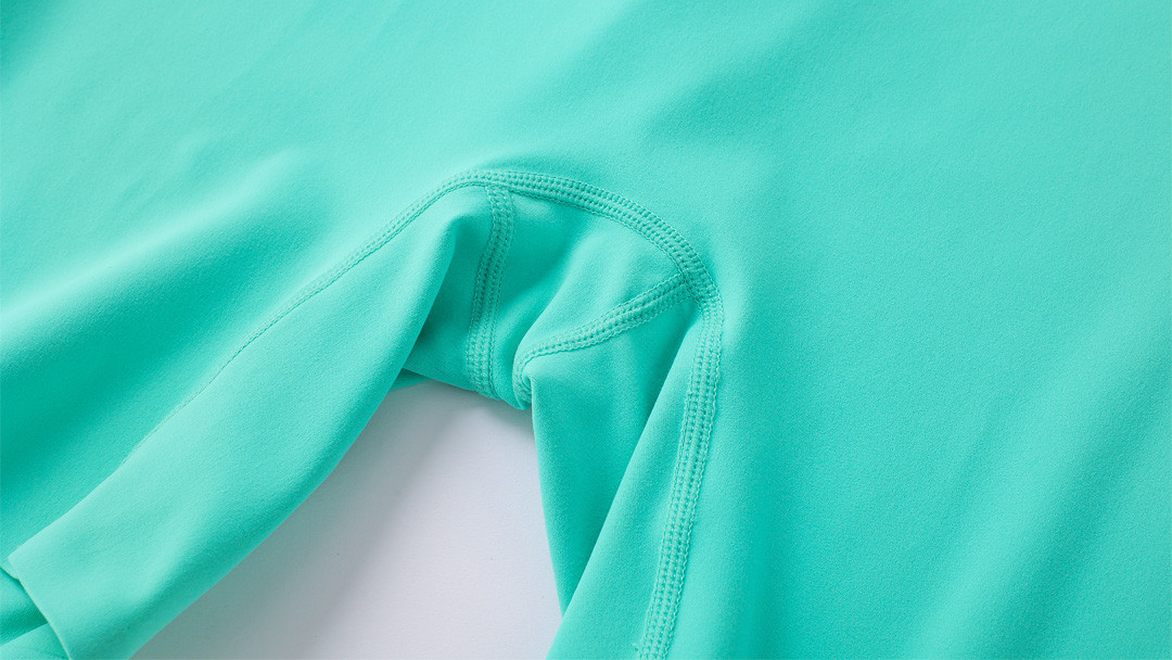 Close-up of diamond gusset and 4-needle flatlock stitching on premium yoga pants