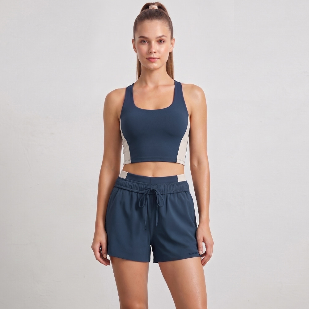 Close-up of the fixed cup sports bra and external drawstring on high-stretch running shorts, built by a reliable activewear factory.