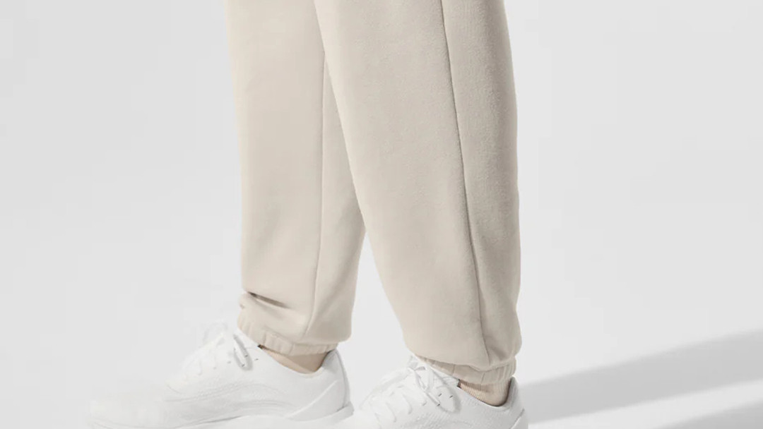 Heavyweight fleece joggers showing gathered elastic ankle cuffs and fabric drape
