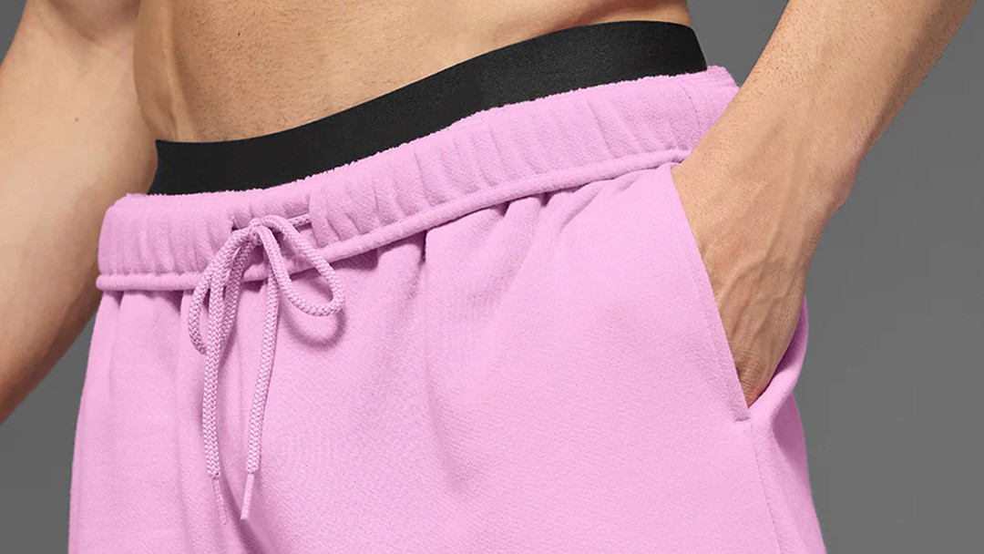 Close-up of heavyweight sweatpants showing a multi-needle stitched waistband and thick drawstring