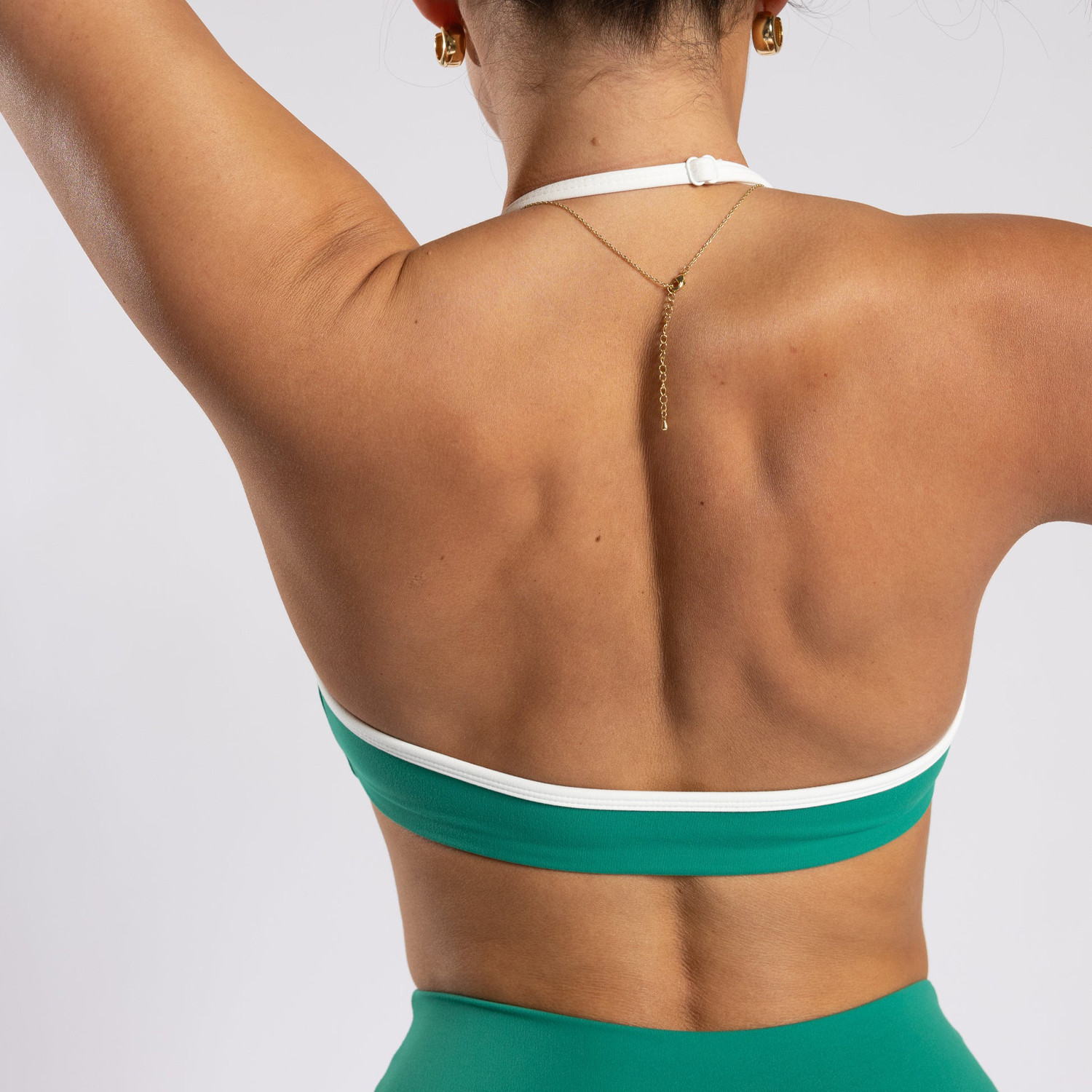 Close-up of the adjustable brushed elastic neck strap and wide back panel on a custom halter bra, crafted for sports bra brands.