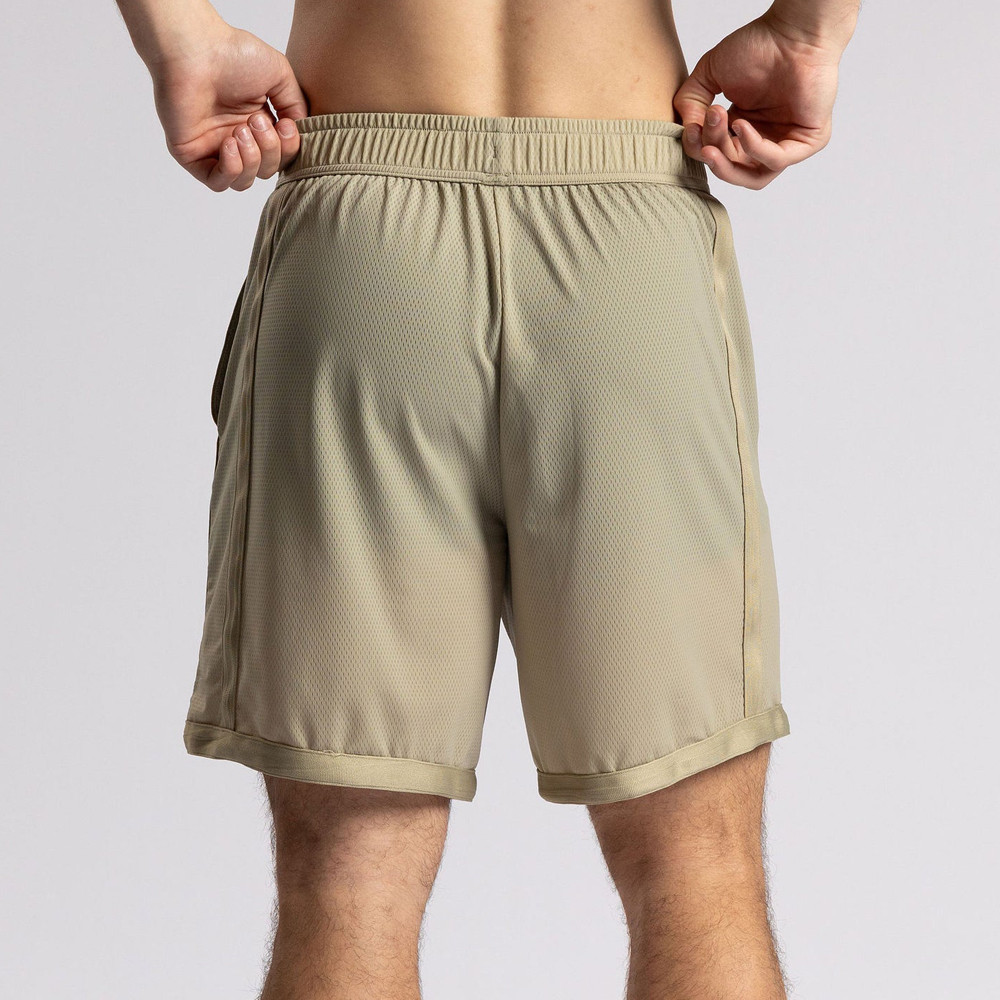 Rear view of beige nylon mesh shorts on a male model, produced by a custom athletic shorts factory.