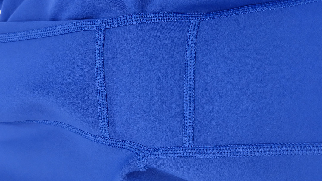 Macro shot of an expanded crotch gusset and heavy-duty flatlock seams on plus-size athletic leggings