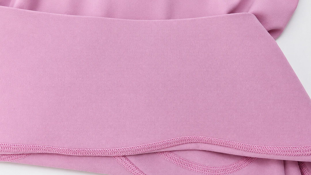 Inside view of a plus-size activewear waistband showing a clean flatlock finish for hidden power mesh support