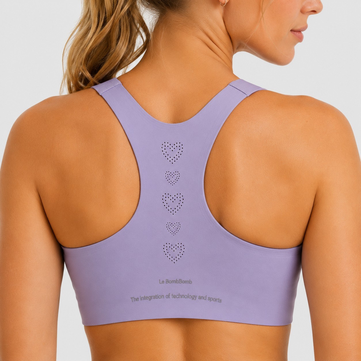 Close-up rear view showing the laser-cut ventilation holes on a custom purple sports bra.