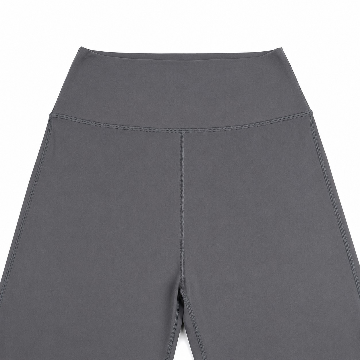 Close-up of the wide waistband and front seam on grey activewear flare pants.
