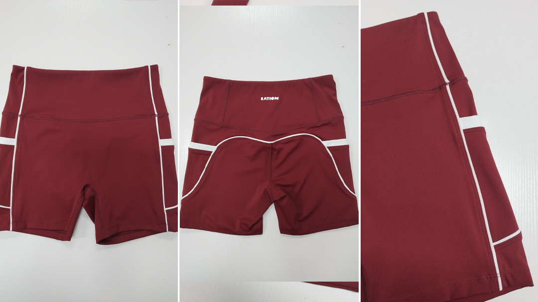 High-waisted burgundy yoga shorts featuring structural V-shaped glute contour stitching and side pockets