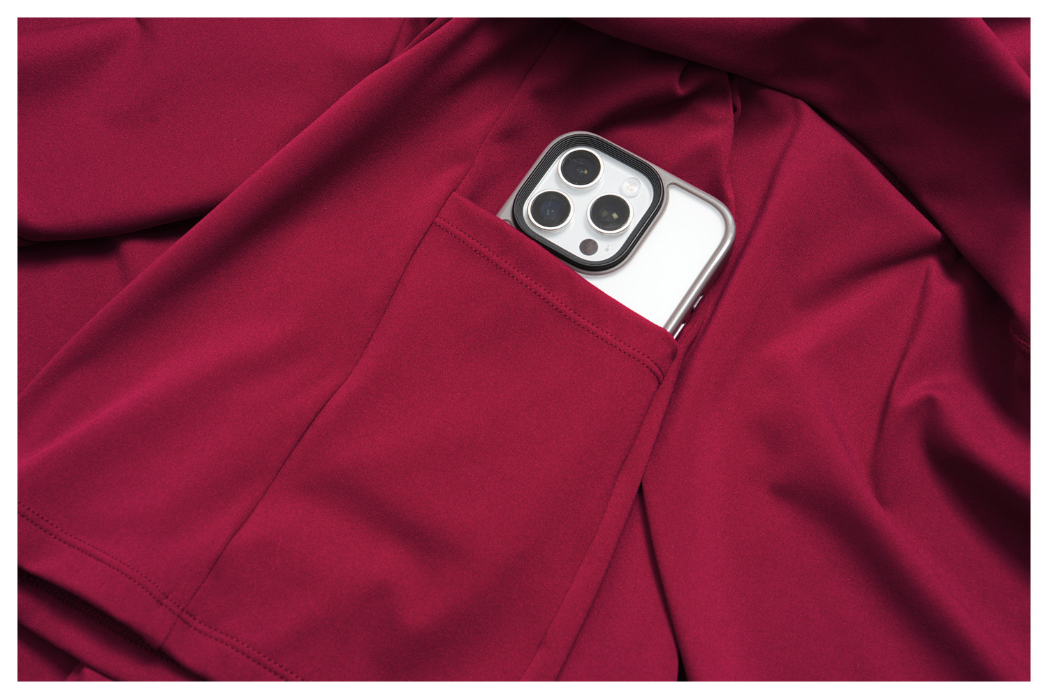 Detailed shot of a smartphone inside the side pocket of the built-in shorts on a tennis dress.