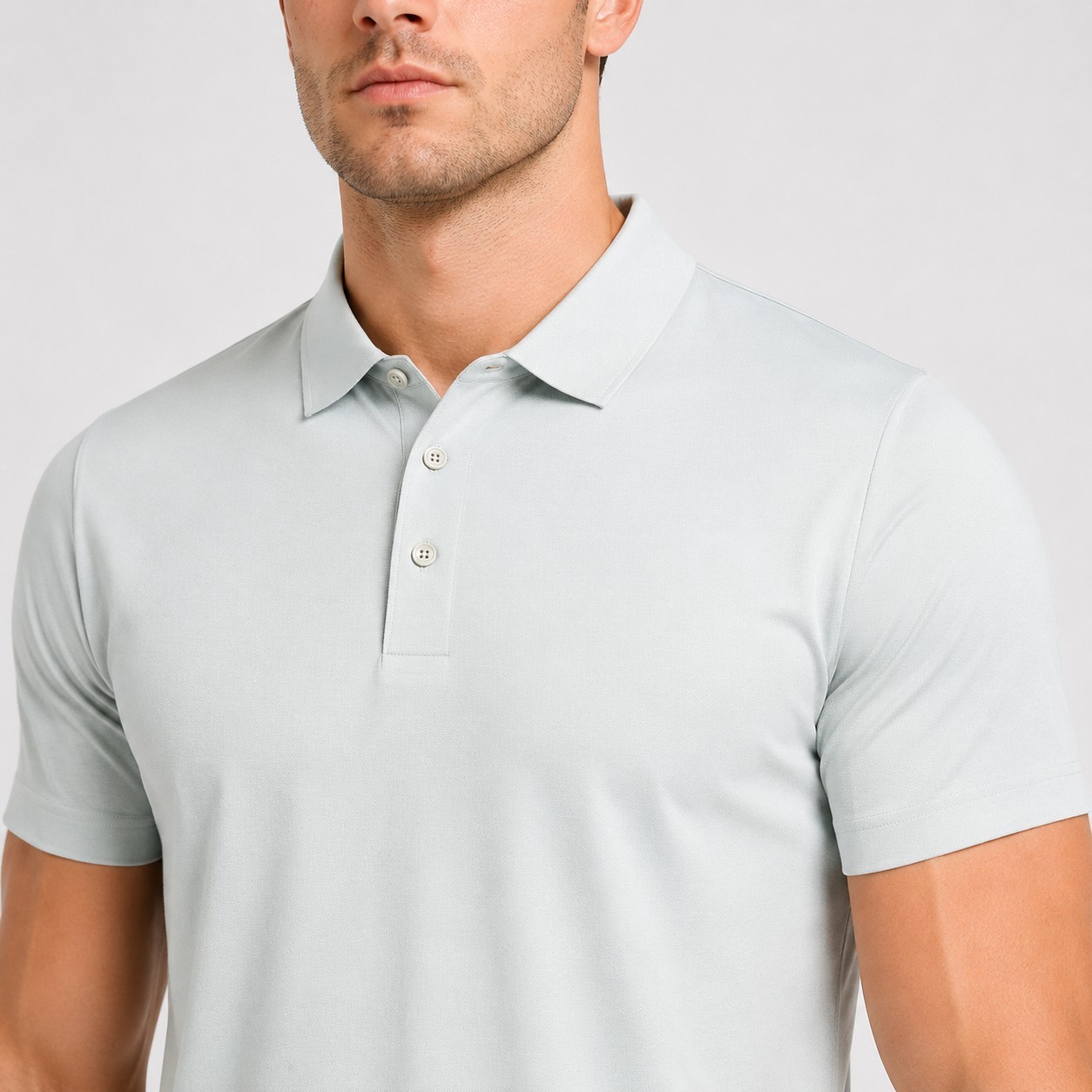 Close-up of the button placket and classic collar on a custom performance polo shirt.