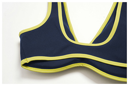 Close-up detailing the contrast binding and clean stitching around the neckline of a sports bra.