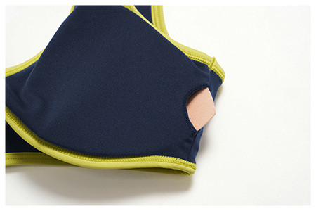 Detailed shot of the inner lining slit for the removable pad on a custom U-back sports bra.