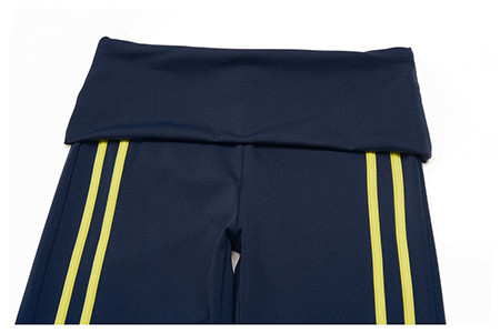Close-up of the fold over waistband and contrast side stripes on custom capri yoga pants.