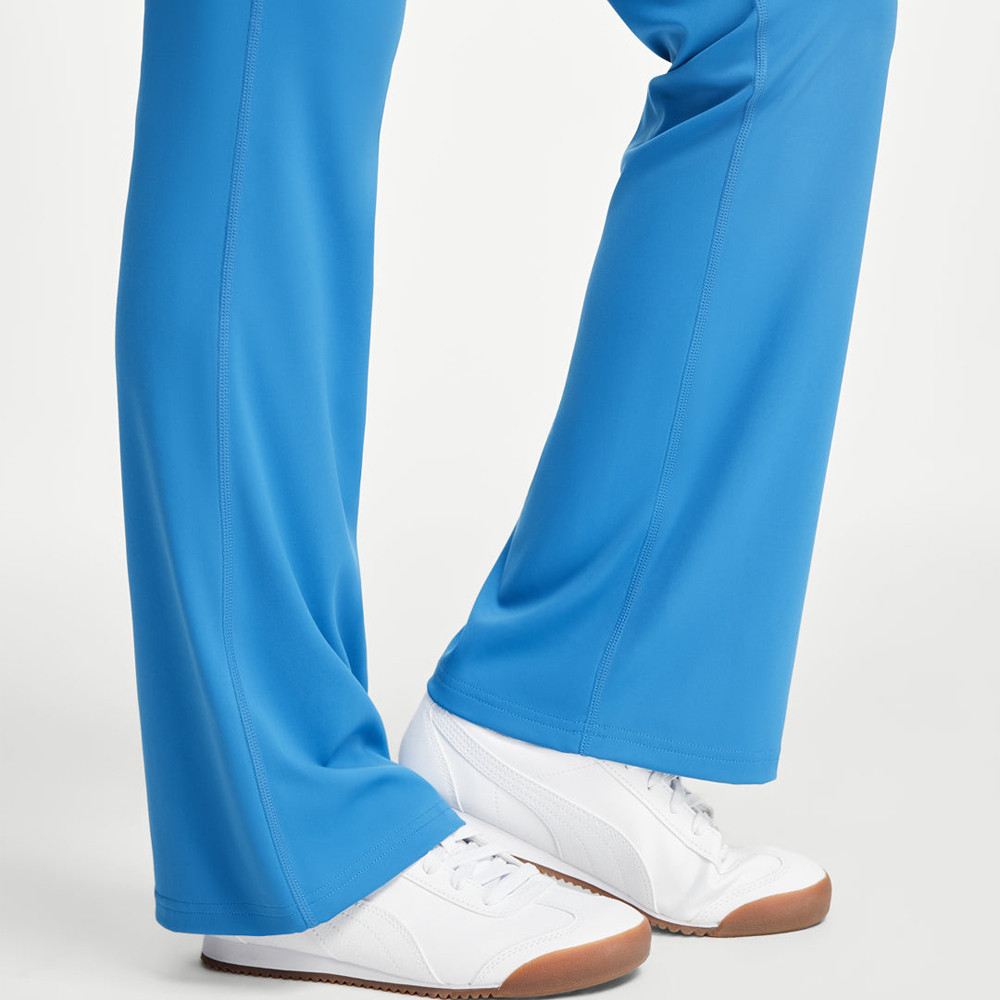 Close-up of the flared leg hem and blue fabric drape on activewear yoga pants.