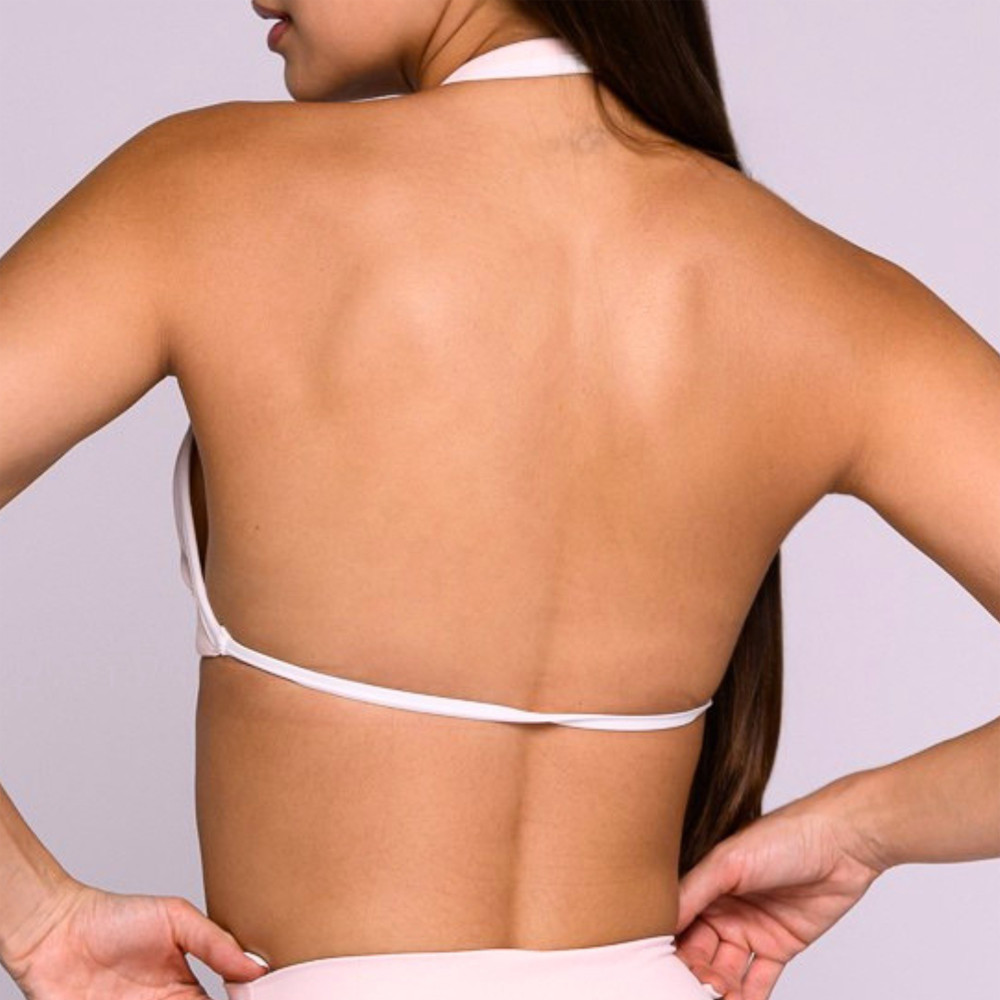Rear close-up view demonstrating the backless construction and halter strap of a pink activewear bra.