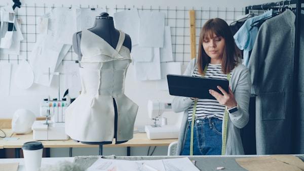 Seamstress using tablet to design activewear