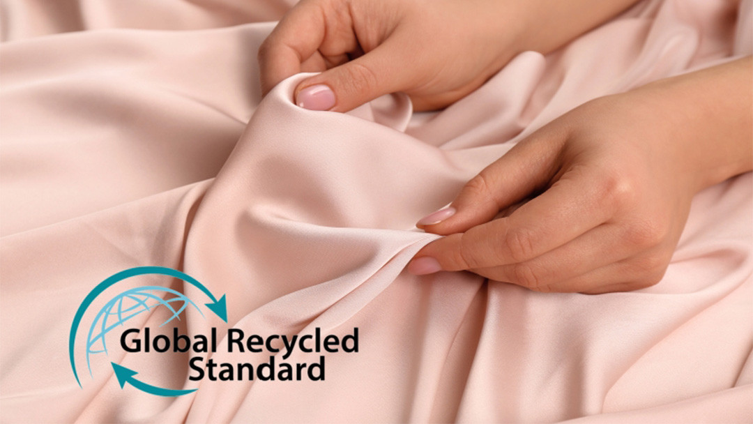 Close-up of premium activewear fabric featuring the Global Recycled Standard (GRS) certification logo.