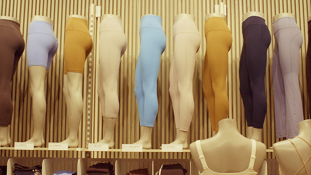 A collection of yoga wear in various colors neatly folded