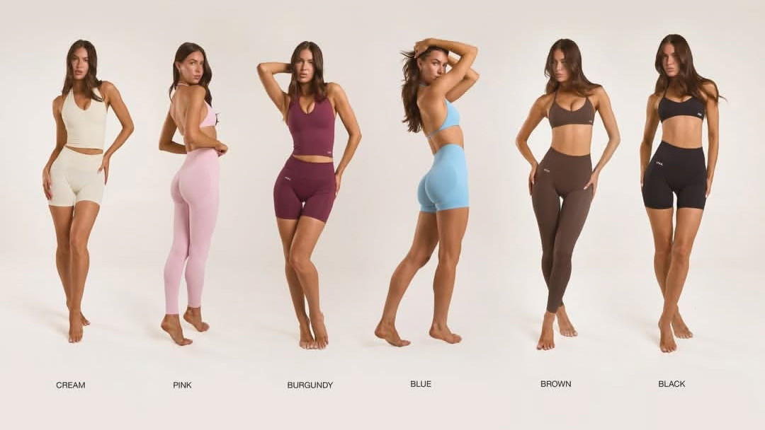 Inspector checking activewear for major defects against an AQL 2.5 standard. Custom women activewear sets showing multiple color options for sportswear production