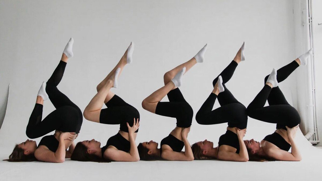 Fabric quality control using the 4-point inspection system. Black activewear sets shown in stretch poses for evaluating fit, comfort, and fabric flexibility