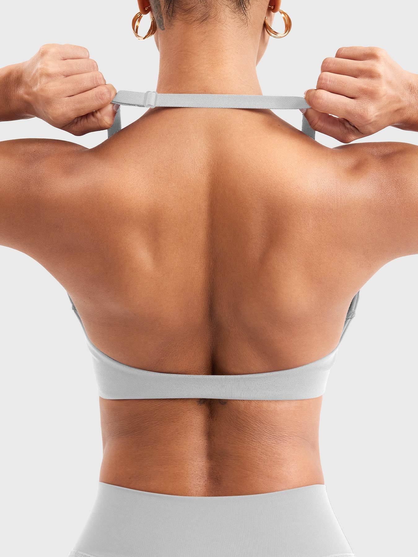 Back view of light gray halter sports bra showing open back construction adjustable neck strap slider and lower back band