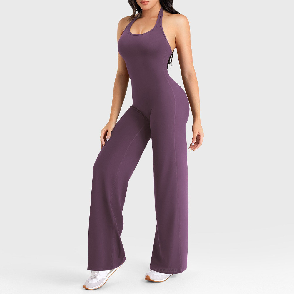 Front full body view of purple halter yoga jumpsuit showing U shaped neckline fitted torso side seams and full length straight leg silhouette