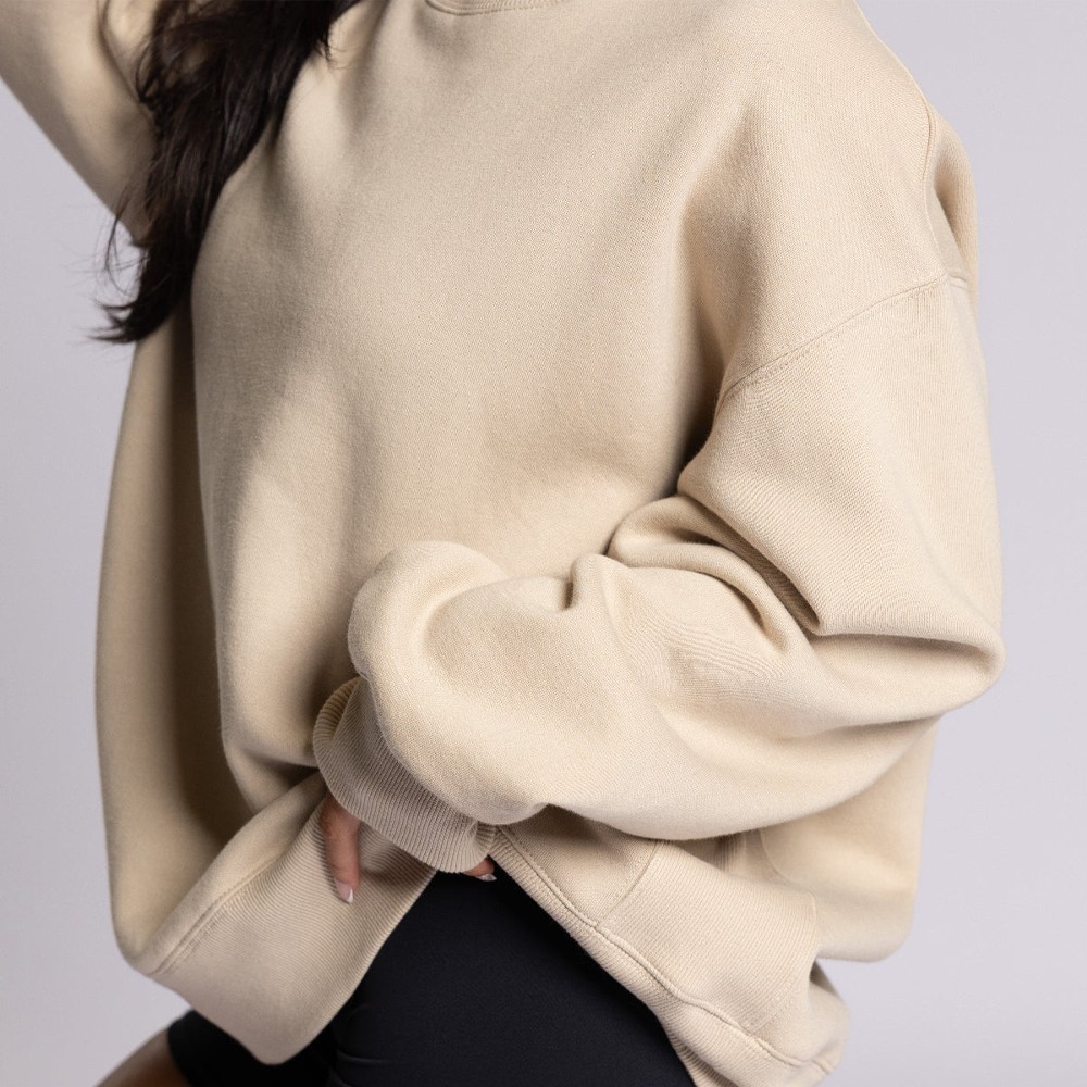 Side detail of sweatshirt showing the ribbed side panel and cuff construction