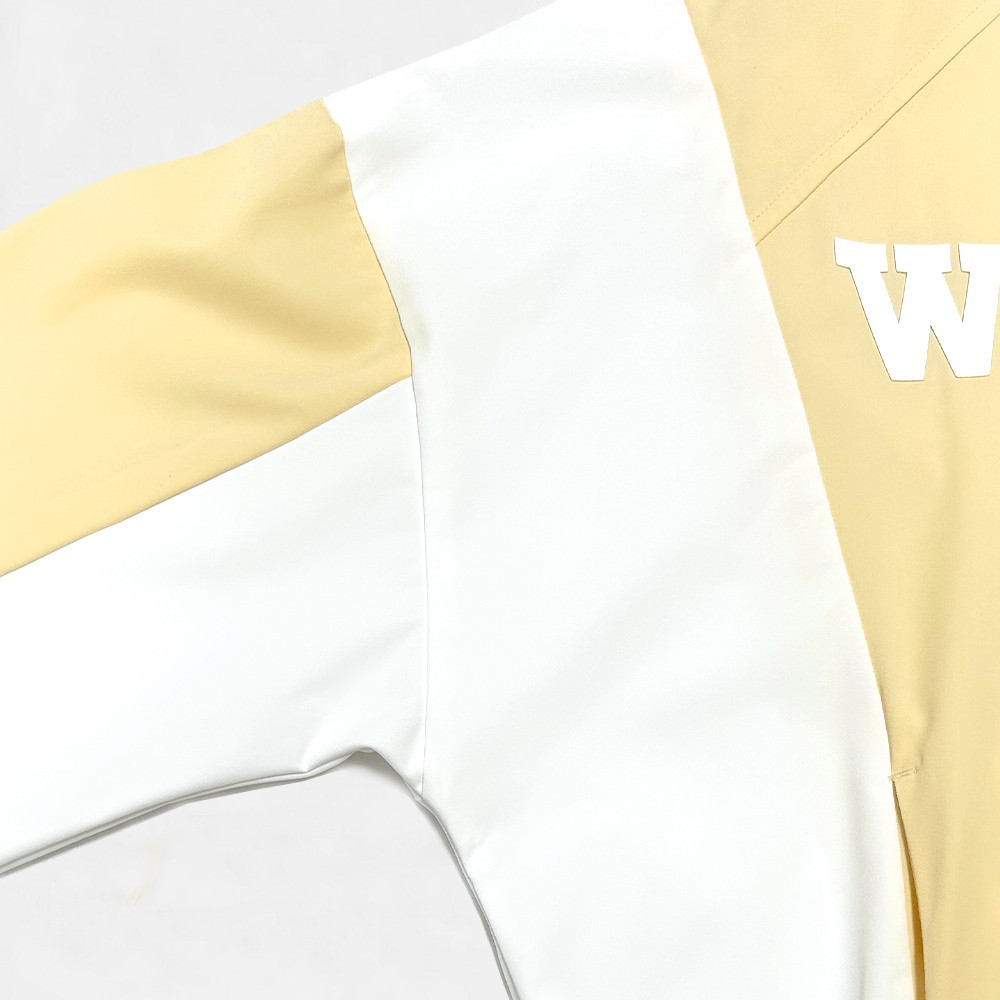 Closeup of the woven twill fabric and color block panel seams showing WON letter print