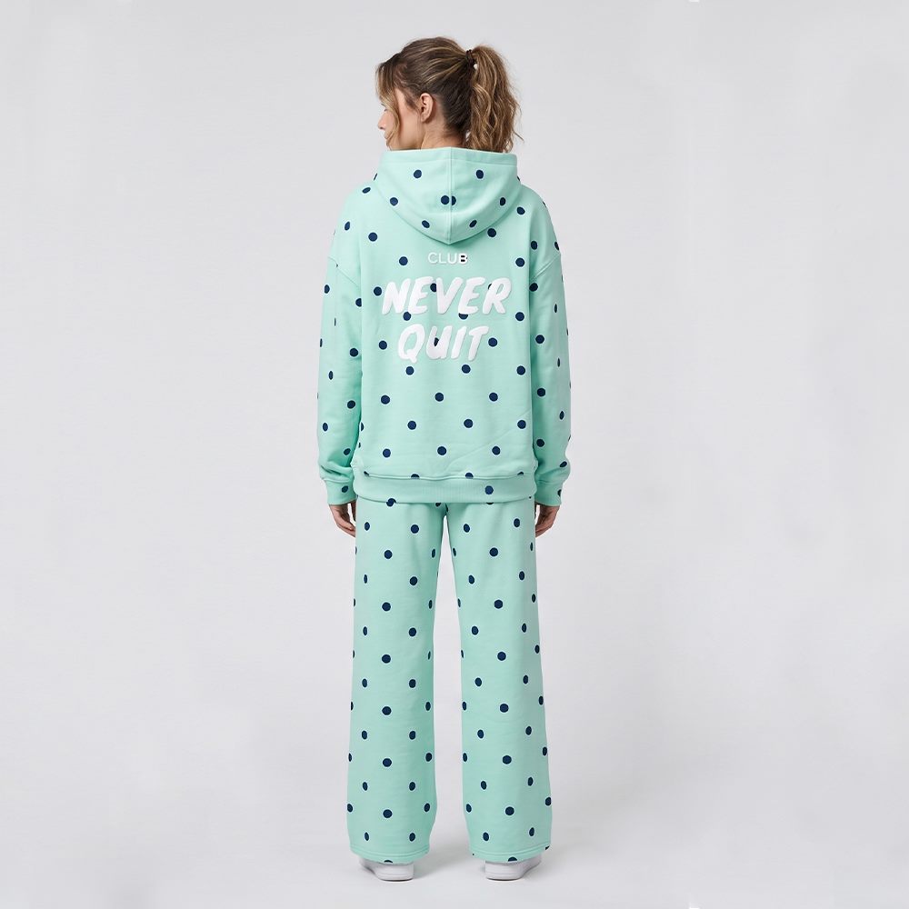 Back view of women's polka dot hoodie and wide-leg pants tracksuit