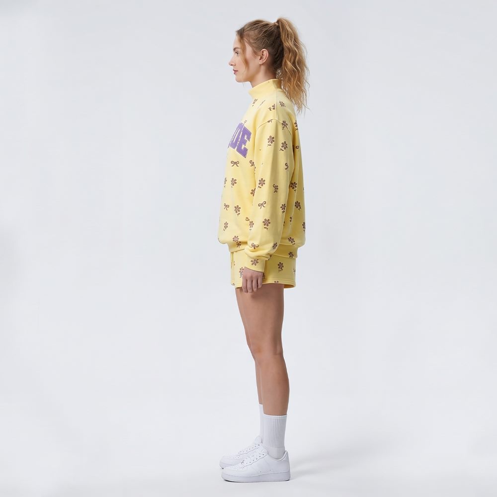 Side view of women's high-neck floral print sweatshirt and shorts set