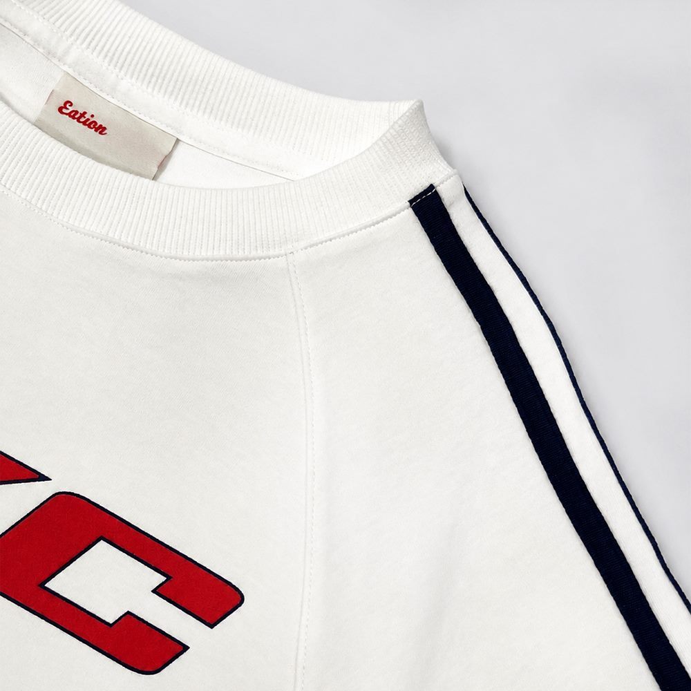 Close view of ribbed crew neckline and partial contrast sleeve webbing