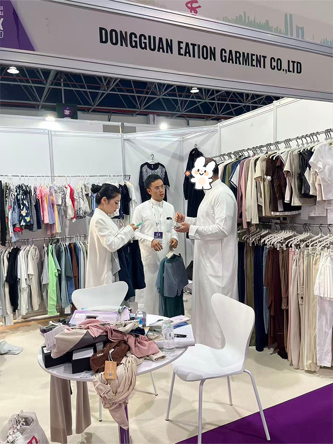 Dongguan Eation Garment booth at Saudi Fashiontex Expo 2026 with team discussing apparel samples