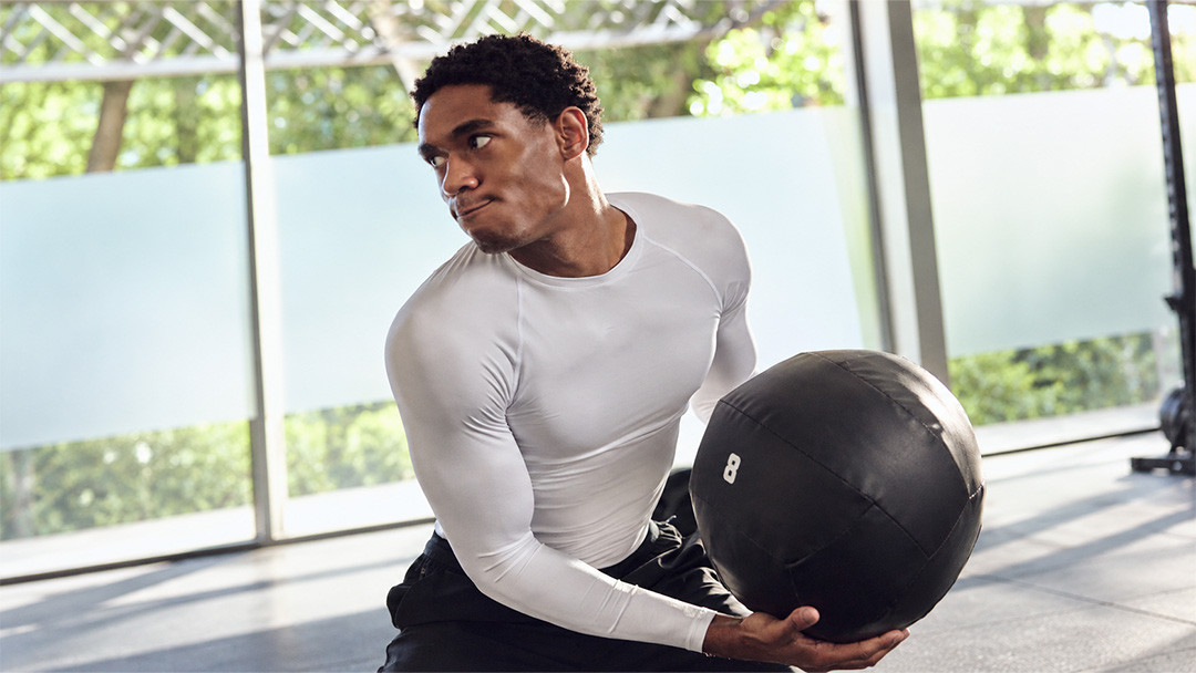 Man wearing a fitted long-sleeve training top during a gym workout