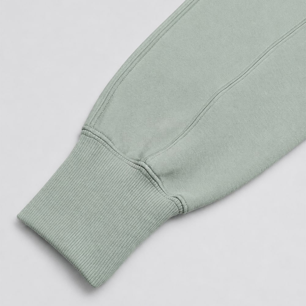 Parallel seam stitching and ribbed sleeve cuff on the sage-green hooded top