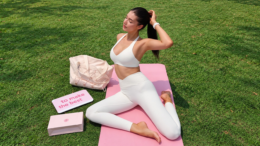 Woman wearing fitted activewear during an outdoor yoga and fitness session
