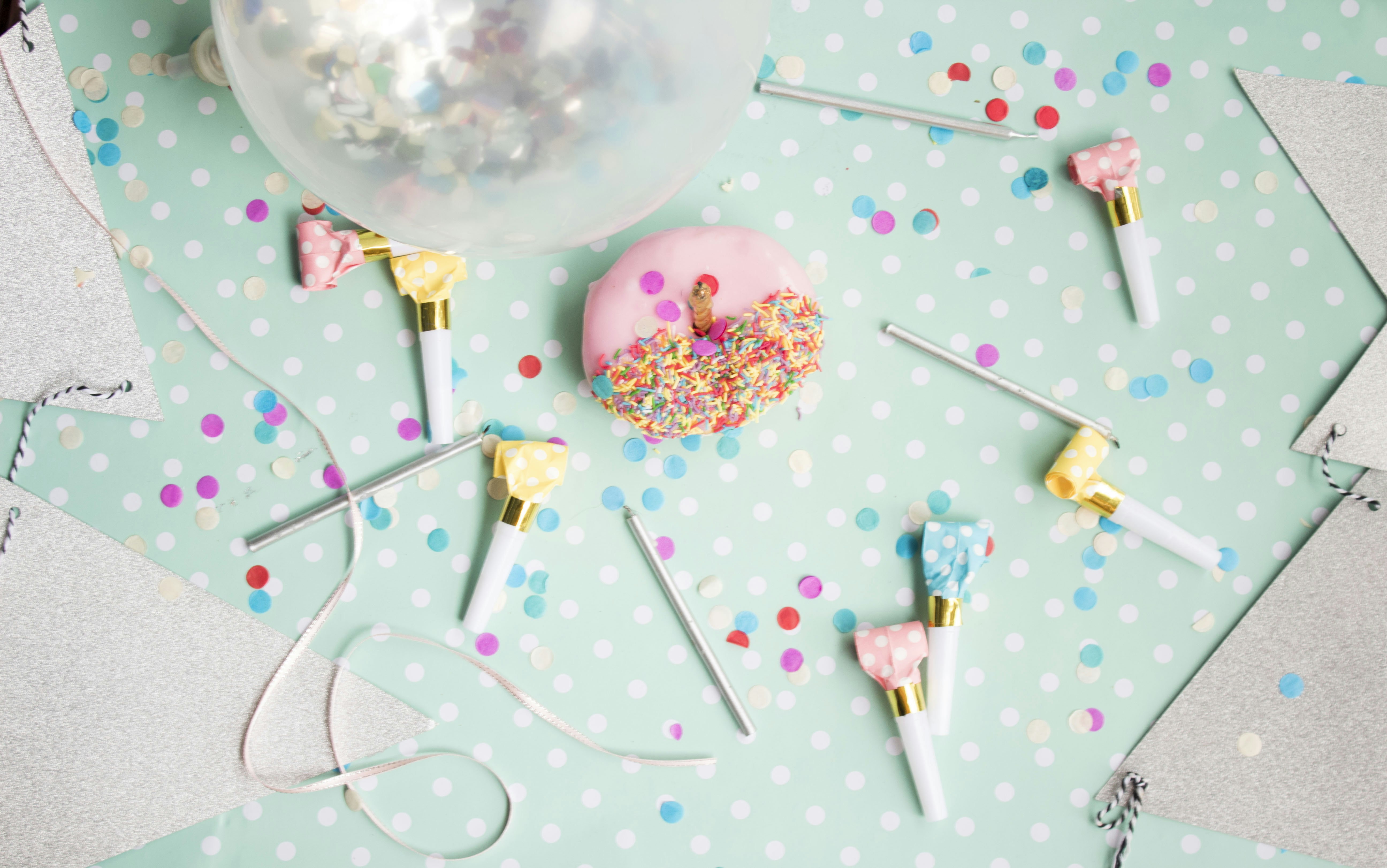 A collection of DIY balloon decorating tools including an electric pump, balloon strip, and glue dots.
