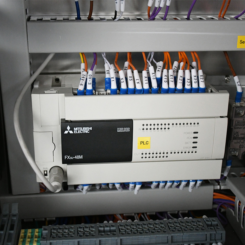 A technician testing the compatibility of a specific pouch material on a packing machine.