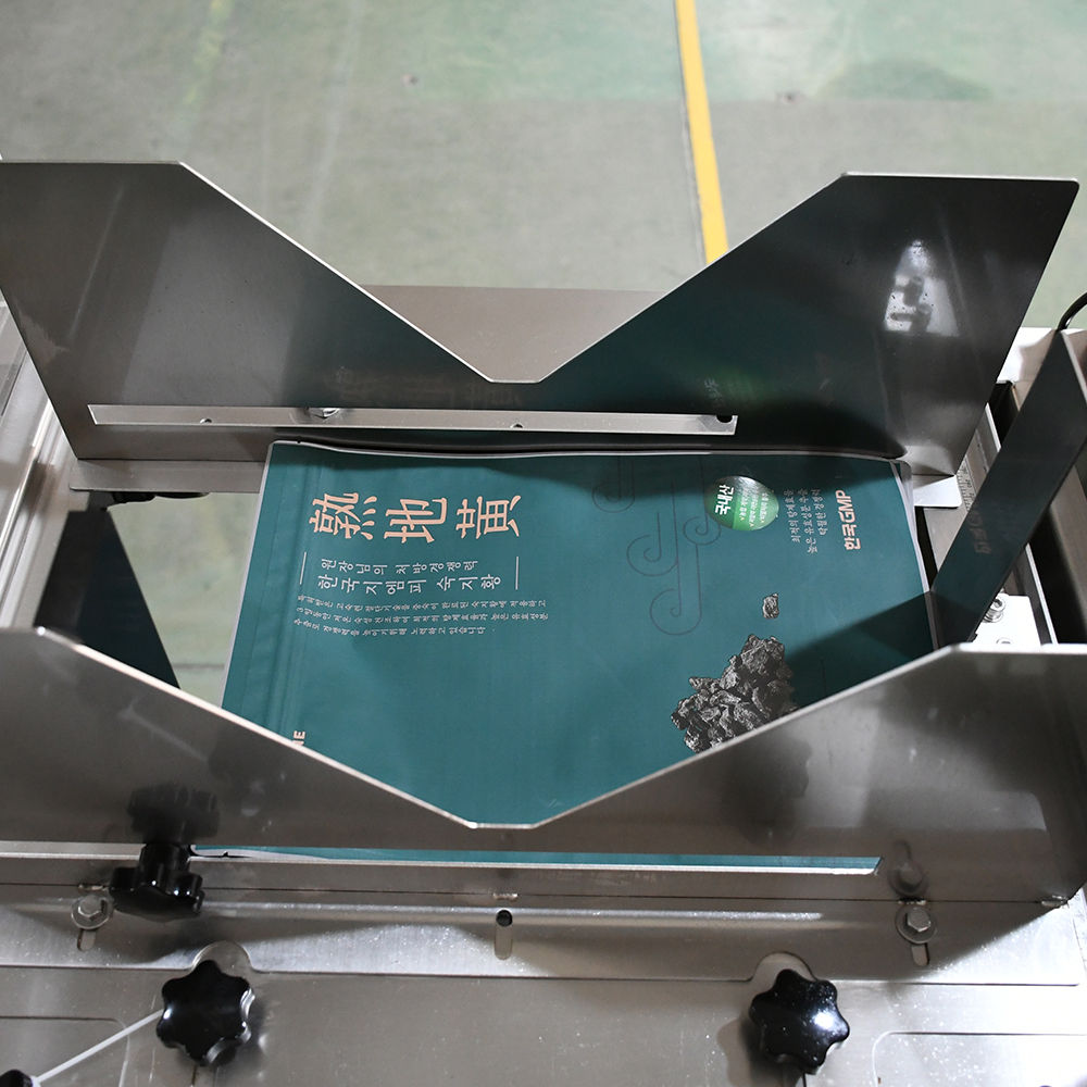 Packages moving along a conveyor on a food packaging line