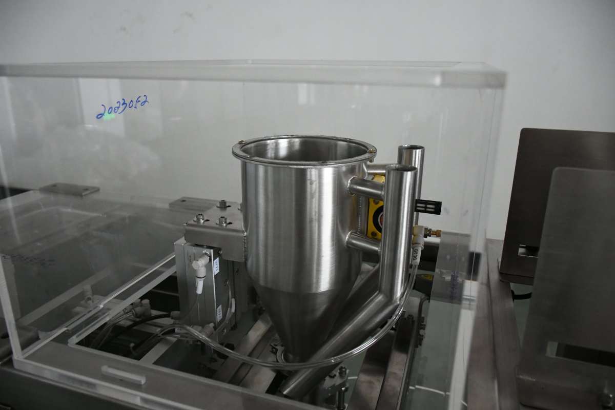 Stainless steel product contact parts under a protective guard on a packaging machine