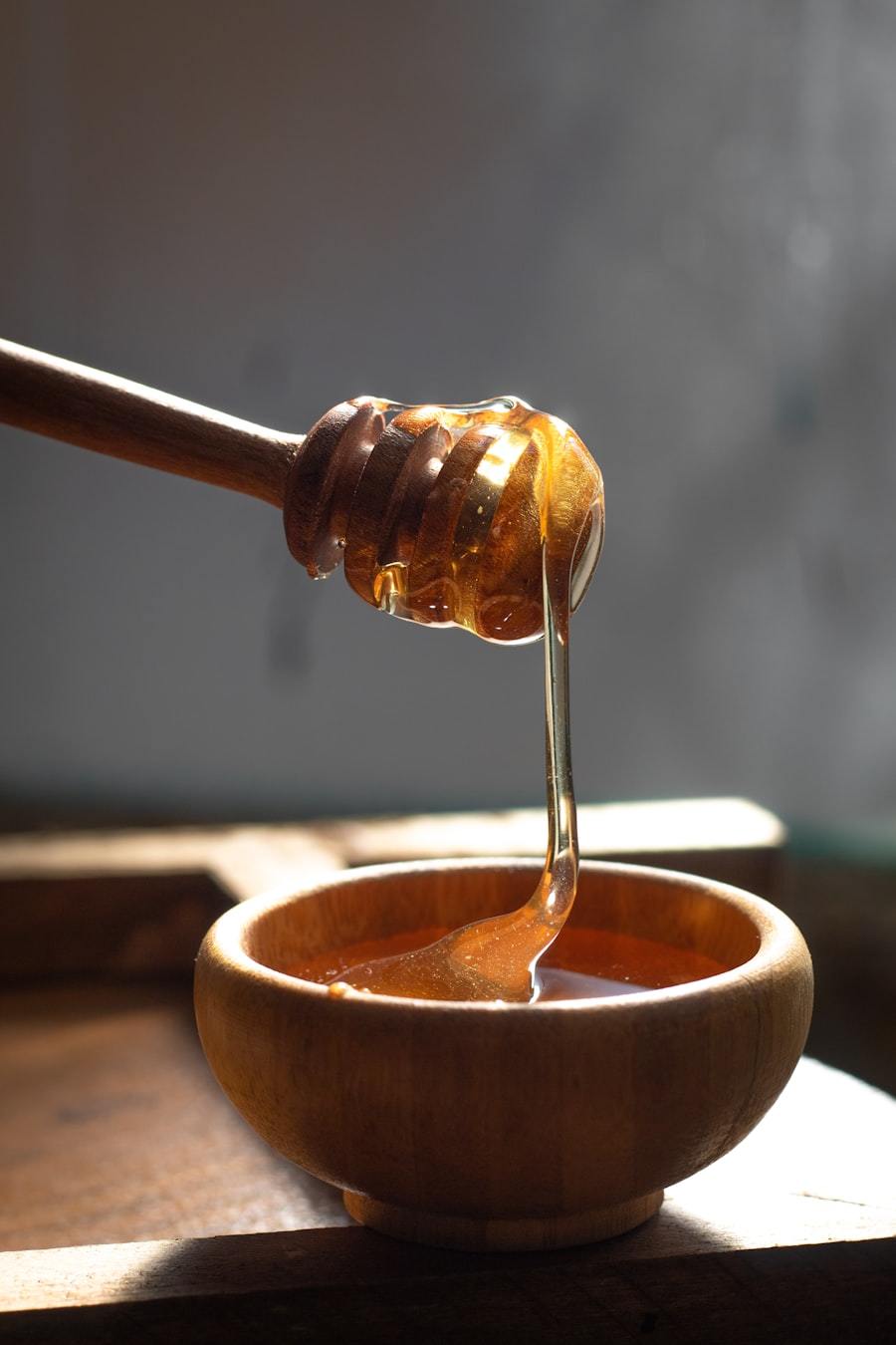 Honey filling machine pouring honey into a jar