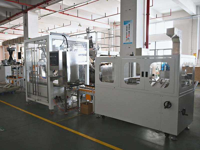 Enclosed food packaging machines under assembly in the production hall