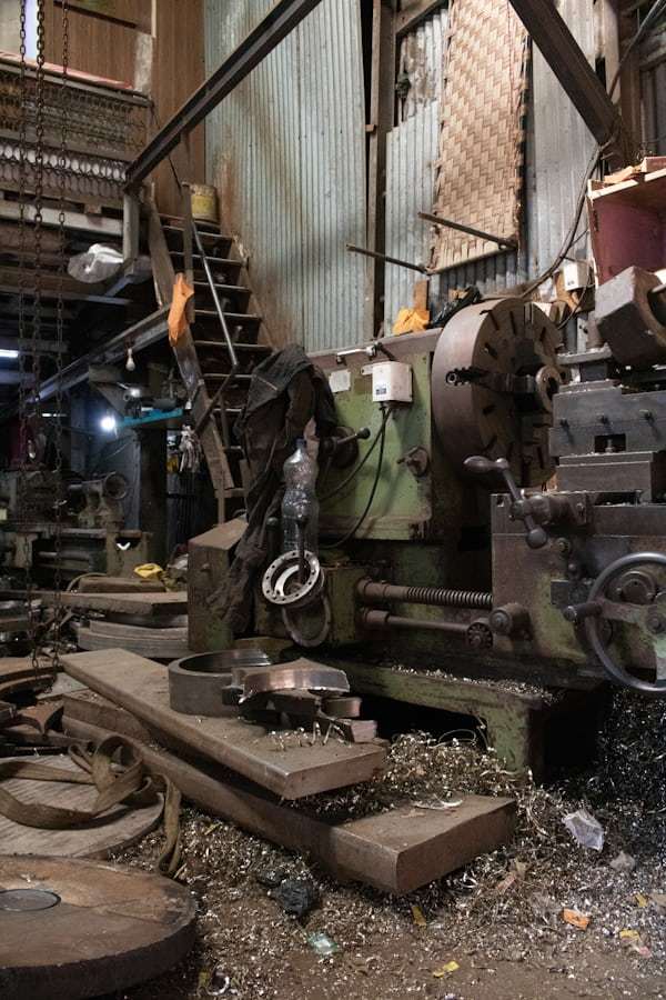 Industrial workshop with lathe producing rod-shaped pulleys