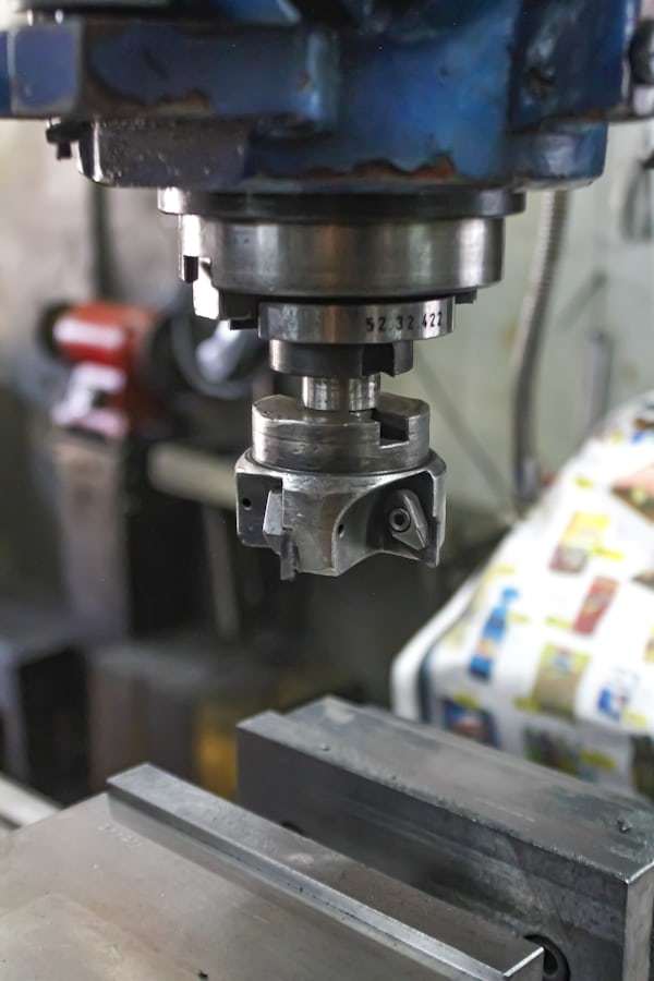 CNC machine working on metal serrated idler gear timing pulley component