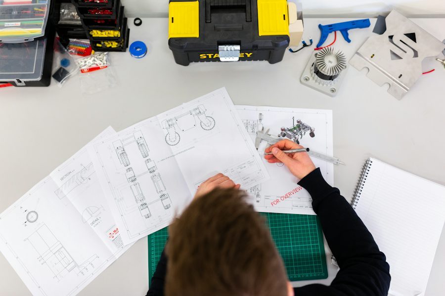 Engineering team reviewing custom timing belt drawings on the factory floor