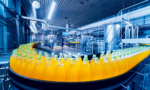 Bottled beverage line in a food plant with conveyor systems running the length of the hall