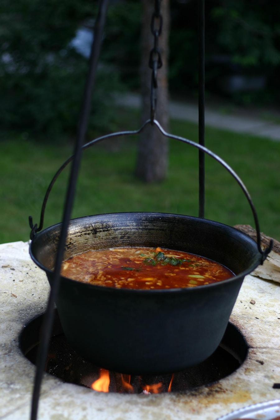 Soup cooking in a large enameled steel hanging pot