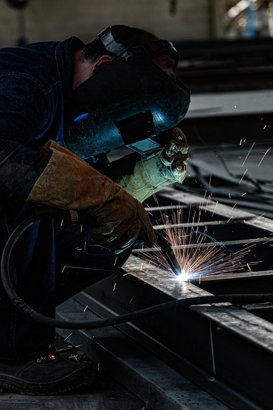 Welding of structural steel beam in fabrication workshop