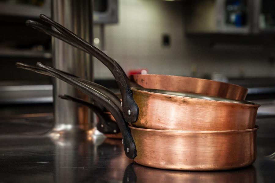 Brass-toned cooking pans showing the polished metal exterior of copper-clad triwall cookware