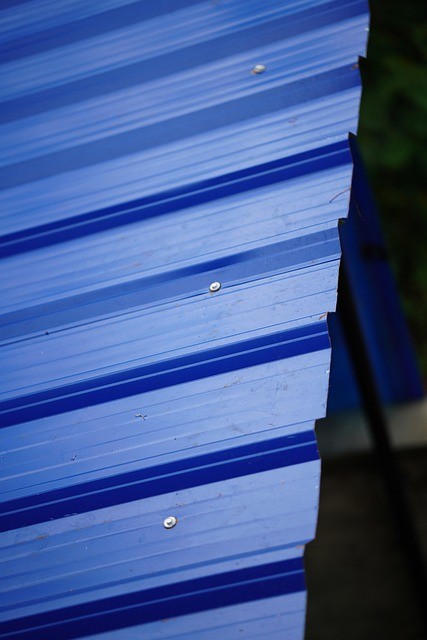 Blue corrugated aluminum roofing panels fixed on a metal roof