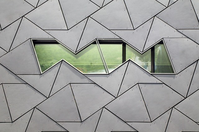 Aluminum roofing and facade panels forming a geometric metal envelope on a modern building